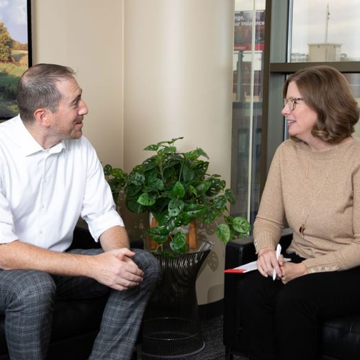 Male CRBT wealth management advisor meeting with a client